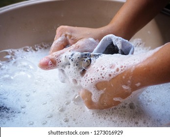 Female Hands Washing Clothes In Basin. Wash Stain Of Dirty Clothing By Hand With Detergent 