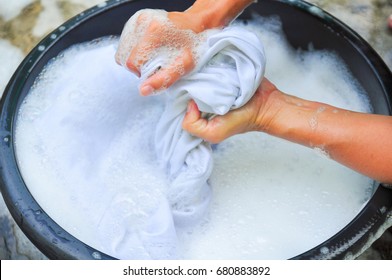 Female Hands Washing Clothes In Basin. Wash Clothing By Hand With Detergent. Water Will Wash Over Wash Machine. Hand Washing.selective Focus And Space For Text.