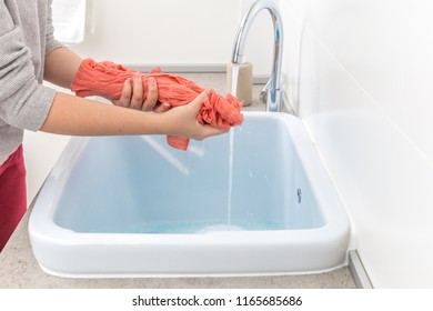 Female Hands Washing Color Clothes In Sink