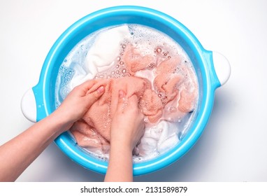 Female Hands Washing Multicolored Towels In Basin, Top View.