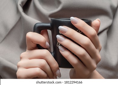 Female Hands With White Nail Design. White Nail Polish Manicure. Woman Hold Black Coffee Cup On Beige Background.