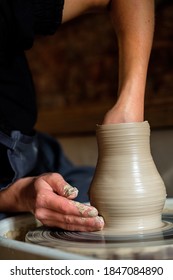 Female hands working with clay on a potter's wheel - Shutterstock ID 1847084890