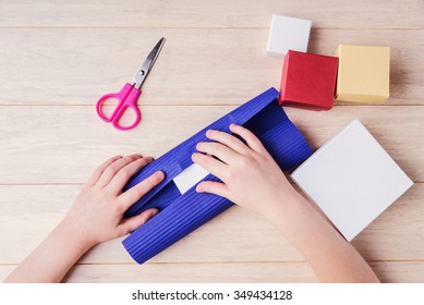 Female Hands Are Wrapping A Gift Box