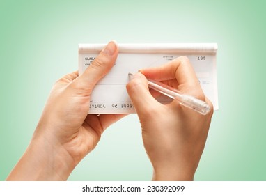 Female Hands Writing A Check