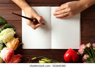 Female Hands Writing Wedding To Do List On Table