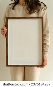 Female hanging wooden frame with empty mockup copy space