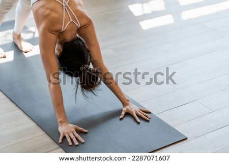 Female happiness Attractive young asian woman doing yoga stretching exercise on mat yoga  fitness exercises. Healthy lifestyle Calmness and relax at home