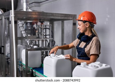 female in hardhat closes the lid of canister with pesticides, preparing plasctic canister in factory, pesticides are used to control various pests and disease carriers. pesticides production - Powered by Shutterstock