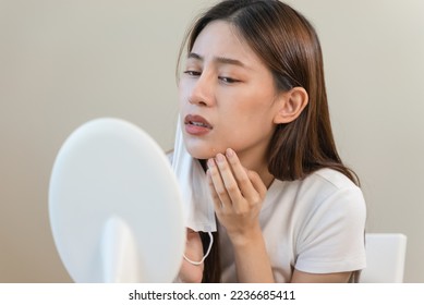 female have an acne problem because wearing face mask. - Shutterstock ID 2236685411