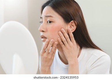 female have an acne problem because wearing face mask. - Shutterstock ID 2324135953