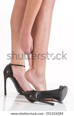female having pain after wearing high heeled shoes