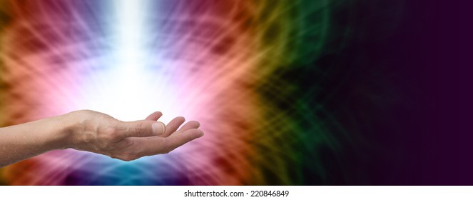 Female Healer With Hand Out Palm Up And A Shaft Of White Energy On Rainbow Colored Energy Formation Background Banner