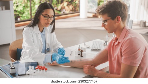 Female Healthcare Professional at Work in Hospital Office. Doctor Applying Different Solutions with Food Allergens on Patient's Forearm. Immunologist Diagnosing any Immediate Allergic Skin Reactions - Powered by Shutterstock