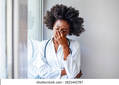 Female Healthcare Worker Having An Headache. Tiredness Or Sickness. Young Female Doctor With A Headache. Closeup Portrait Sad Health Care Professional With Headache, Stressed.