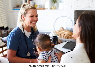 Female healthcare worker visiting a young mum and her infant son at home, close up