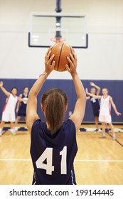 Female High School Basketball Player Shooting Basket