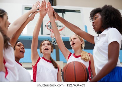 Female High School Basketball Players Joining Hands During Team Talk With Coach - Powered by Shutterstock