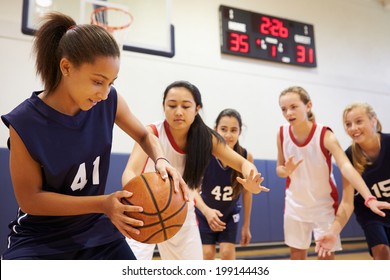 Female High School Basketball Team Playing Game - Powered by Shutterstock