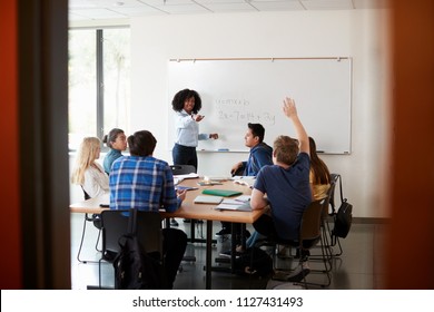 Female High School Tutor At Whiteboard Teaching Maths Class With Pupil Asking Question - Powered by Shutterstock