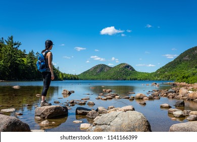 Female hike at Jordan Pond in Acadia National Park, Maine. 