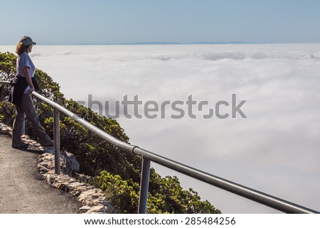 Female hiker admiring the view of the Marin County and San Francisco bay area from the top of Mountain Tamalpais, Marin, California