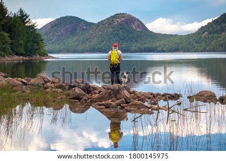 Female hiker and dog at Jordan Pond and The Bubbles, Acadia National Park, Maine