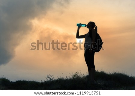 Female hiker drinking bottle of water. 