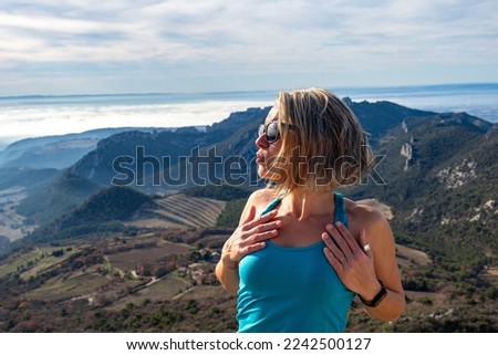 Female hiker enjoying the views of Les Dentelles de Montmirail while traveling through sightseeing Provence France