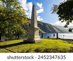 Female Hiker And Historical Captain James Cook Monument on The Shore of Kealakekua Bay, The Captain Cook Monument Trail, Captain Cook, Hawaii Island, Hawaii, USA