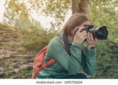 Female Hiker And Landscape Photographer Photographing Nature With Camera While Trekking On Summer Vacation