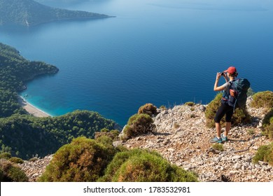 Female hiker making photo of the beautiful landscape of Mediterranean coast near Antalya, Turkey. Walking the Lycian way hiking trail in Antalya region