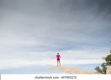 A Female Hiker Standing On Top Of Potato Chip Rock In Southern California. 