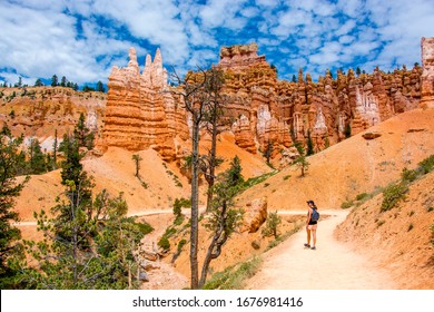 female hiker tourist on the navajo loop trail in the bryce canyon national park on a sunny day with blue sky in summer