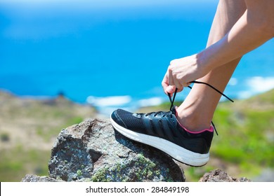 Female Hiker Tying Her Shoe. 