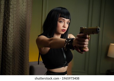 A Female Hitman In A Hotel Aims A Gun At A Victim With A Scared Face