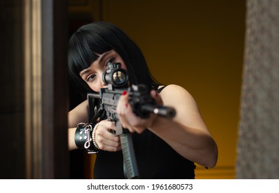 A Female Hitman In A Hotel Near The Window Aims An Automatic Rifle With A Telescopic Sight At The Victim Committing Murder