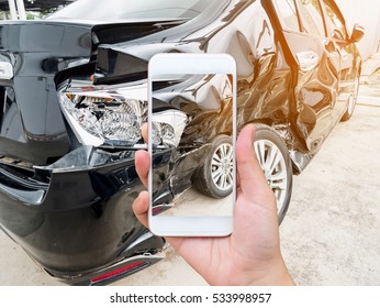 female hold mobile smartphone photographing car accident for insurance