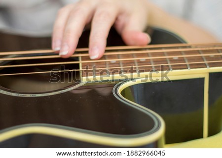 Female holding An acoustic bass guitar and play music
