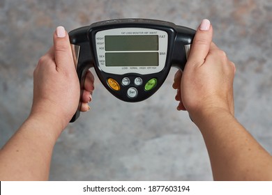 A Female Holding A Fat Loss Monitor A Grunge Background