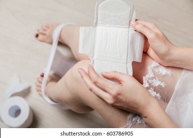 Female Holding Female's Hygiene Means