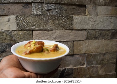 Female Holding Kadhi Pakoda An Indian And Pakistani Food.Gramflour Fritters Dunked In Spiced Curd