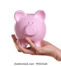 Female holding a pink piggy bank