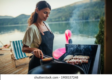 Female holding skewer with meat and putting on barbecue - Powered by Shutterstock