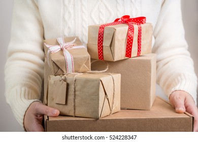 Female Holding Stack Of Christmas Presents. Christmas Concept