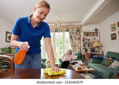 Female Home Help Cleaning House And Talking To Senior Woman - Powered by Shutterstock