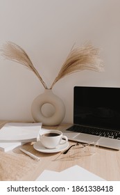 Female Home Office Desk Workspace. Blank Screen Laptop Computer With Copy Space. Coffee Cup, Pampas Grass In Stylish Vase On Beige Wooden Table. Minimalist Lifestyle Blog Mockup.