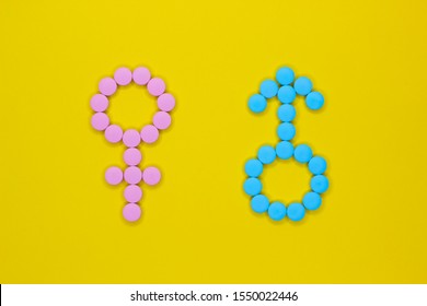 Female hormones estrogen: estradiol, estriol and progesterone and male hormone testosterone. Gender signs from pills on yellow background. Anabolic.