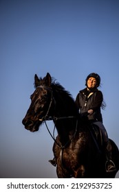 Female Horse Rider Riding Outdoors On Her Lovely Horse