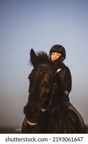 Female Horse Rider Riding Outdoors On Her Lovely Horse