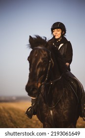 Female Horse Rider Riding Outdoors On Her Lovely Horse